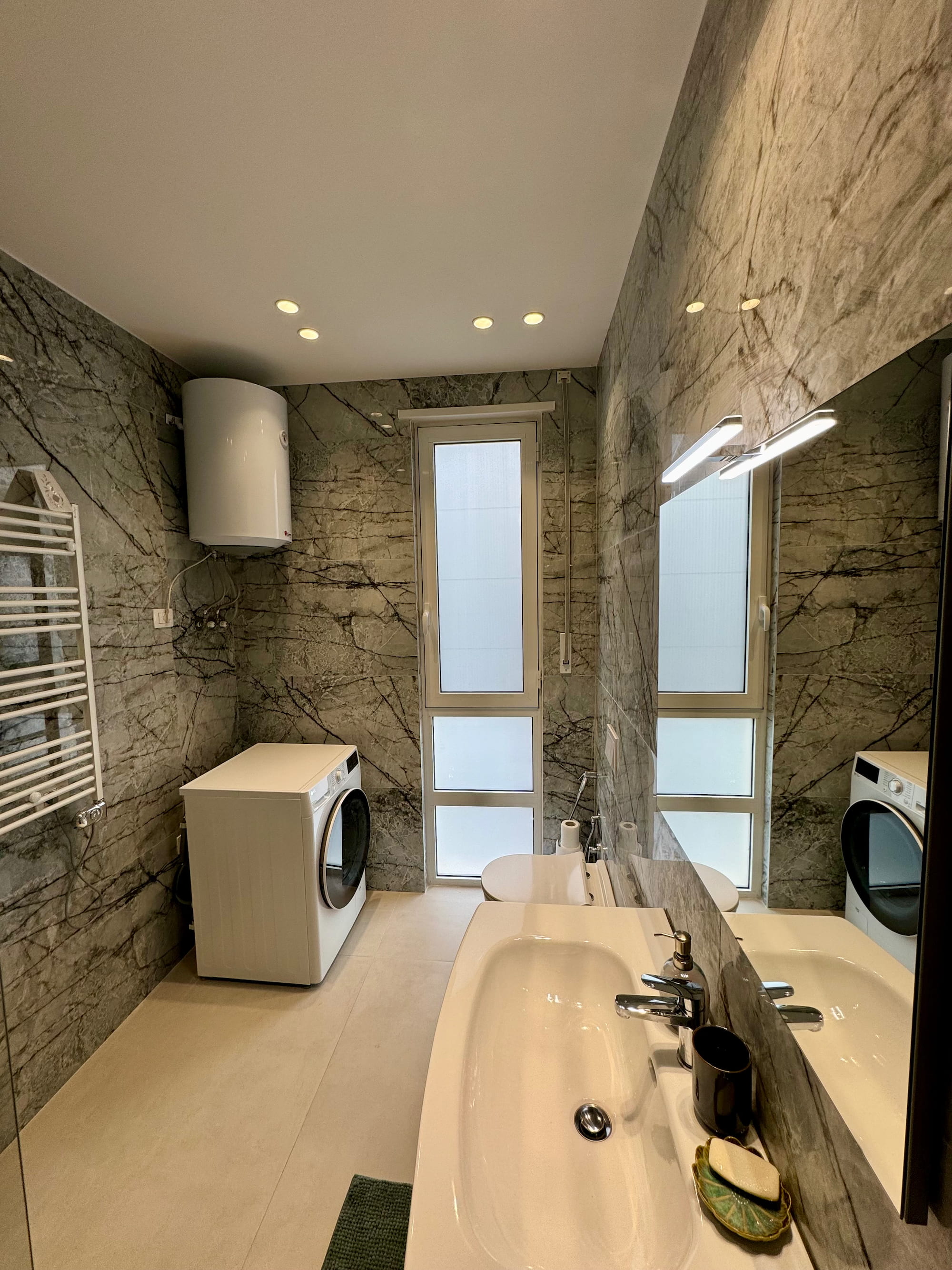 Marble bathroom with washer-dryer